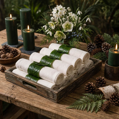 Banana leaf napkin rings on rolled white napkins in a wooden tray - thumbnail number 4
