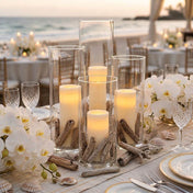 Glass cylinder candles with driftwood pieces for a beach wedding table - thumbnail number 4