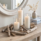 Glass cylinder candles surrounded by driftwood pieces on a console table - thumbnail number 8