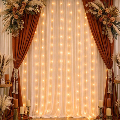 A wedding backdrop featuring warm white battery-operated LED fairy lights behind sheer curtains - thumbnail number 8
