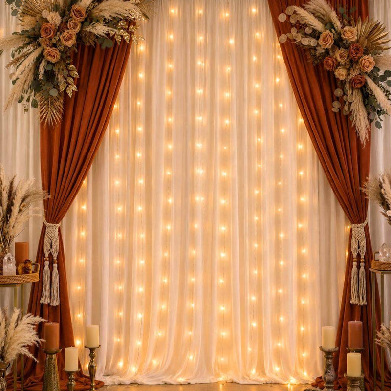 A wedding backdrop featuring warm white battery-operated LED fairy lights behind sheer curtains - thumbnail number 8