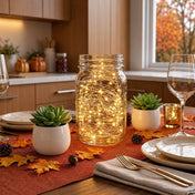 A glass mason jar filled with warm white battery-operated LED fairy lights on a table - thumbnail number 11