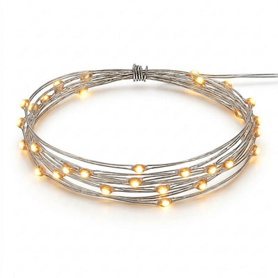 A coiled strand of glowing warm white battery-operated LED fairy lights on a white background - thumbnail number 1