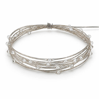 A coiled coil of battery-operated warm white LED fairy lights on a white background - thumbnail number 2