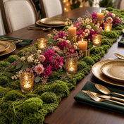 A dining table centerpiece with a faux moss runner, candles, and pink and white flowers - thumbnail number 4