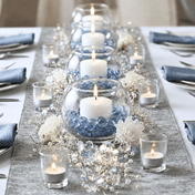Wedding table centerpiece with candles, blue gems, and white flowers on a silver runner - thumbnail number 4
