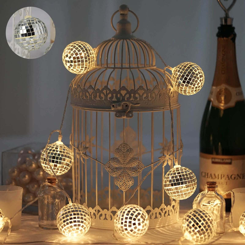 Decorative fairy lights on a vintage birdcage with champagne in the background. - thumbnail number 1