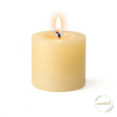A scented lit ivory pillar candle on a white background - thumbnail number 4