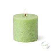 Lit green scented votive candle burning on a white background - thumbnail number 2
