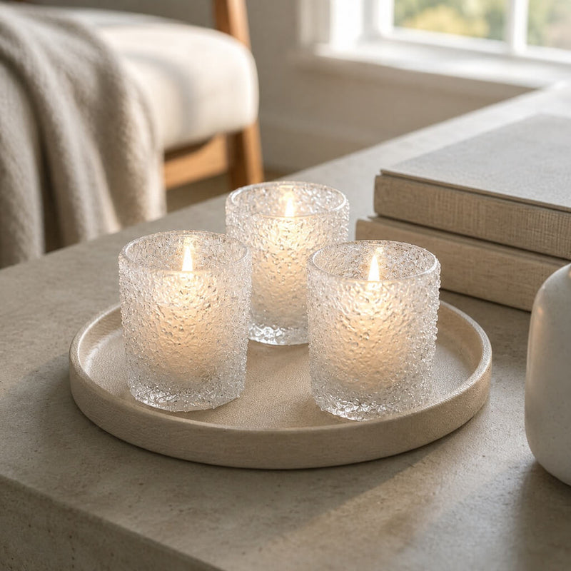 Frosted sparkle votive holders glowing on a tray in a cozy modern living space - thumbnail number 7