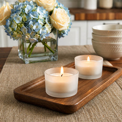 Lit frosted glass tealight holders beside floral arrangement - thumbnail number 7