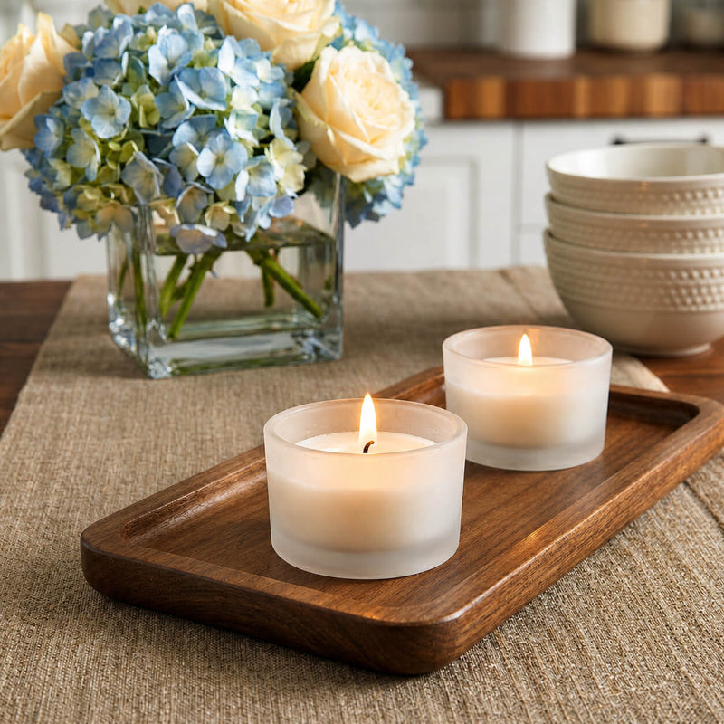 Lit frosted glass tealight holders beside floral arrangement - thumbnail number 7
