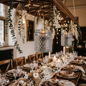 Festive dining decor with lit glass lanterns and floral arrangements. - thumbnail number 6