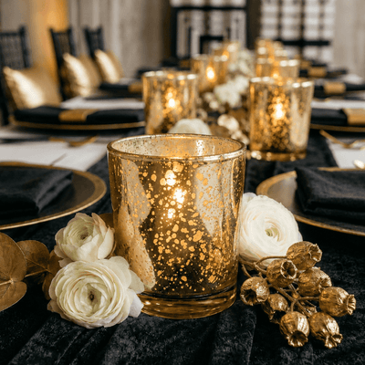 Amber Gold Mercury Votive Holder with lit candle on black tablecloth among white ranunculus flowers - thumbnail number 6