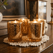 Four lit Amber Gold Mercury Votive Holders arranged on a lace doily atop a wooden surface - thumbnail number 8