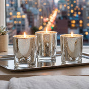 Three lit Silver Mercury Votive Holders on a silver tray with a blurred city view in the background - thumbnail number 7