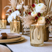 An elegant event tablescape featuring a lit candle inside a Metallic Gold Mercury Votive Holder - thumbnail number 5