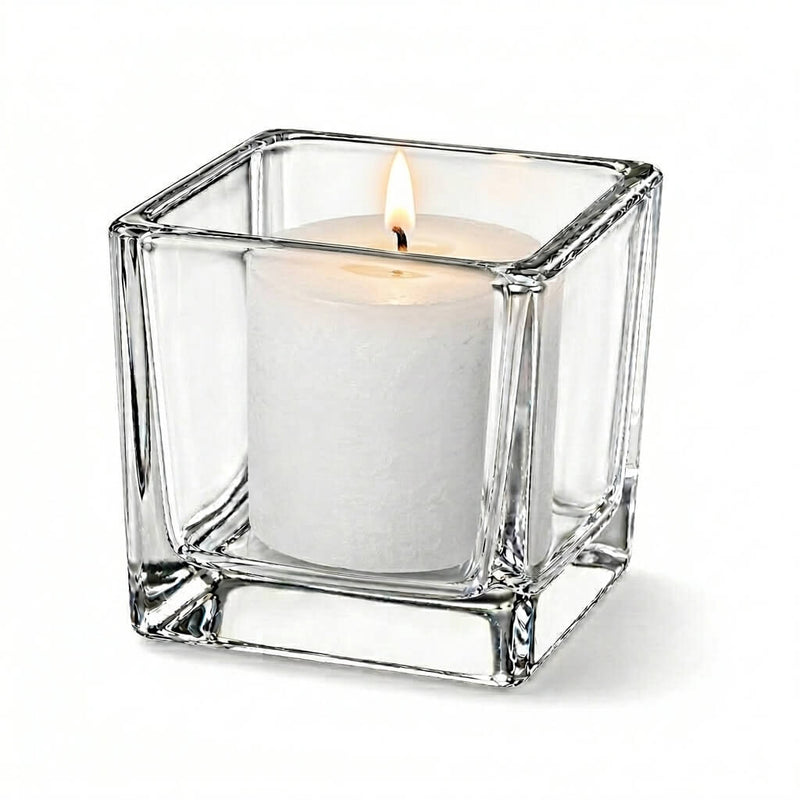 Lit white candle in clear square glass holder on white background - thumbnail number 3