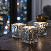 Set of glowing silver mercury square votive holders on a wooden table at night - thumbnail number 7