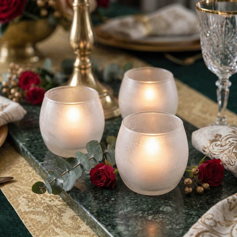 Three frosted glass votives with red roses and eucalyptus on a green marble tabletop runner - thumbnail number 5