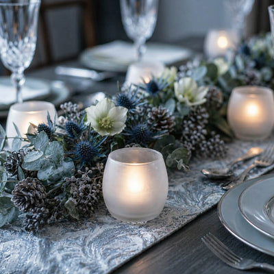 Frosted glass votives with blue thistles and pinecones on a silver patterned table runner - thumbnail number 6