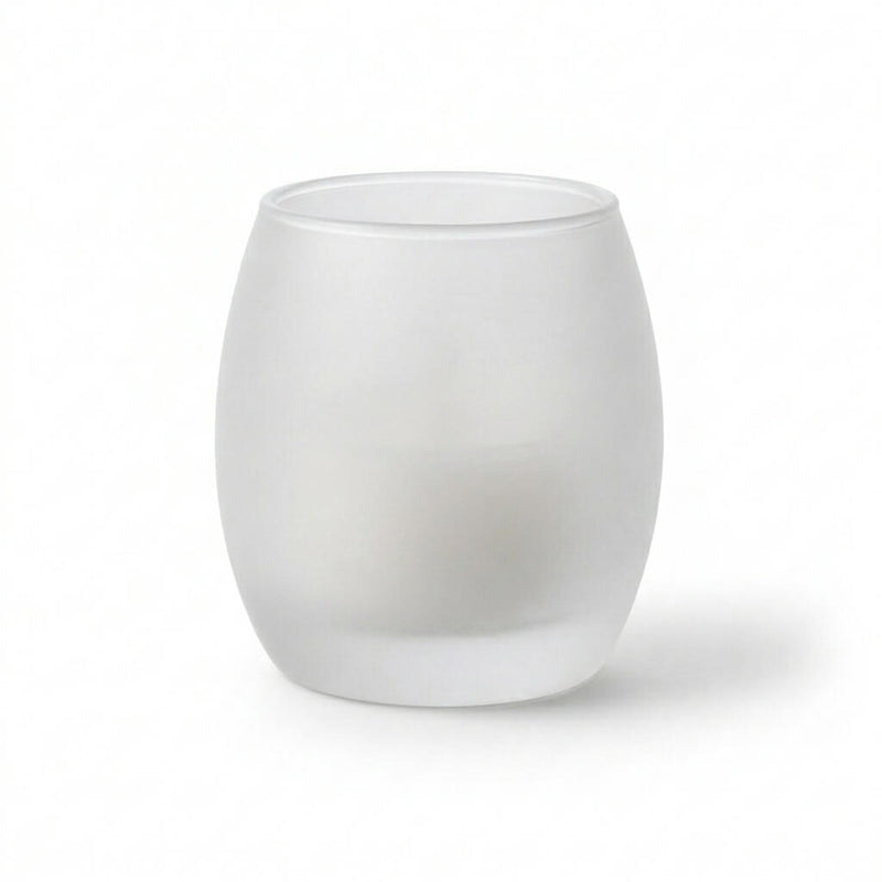 Frosted glass votive holder containing a white candle against a plain white background - thumbnail number 2