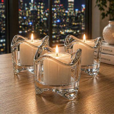 Three swirl top glass votive holders with lit candles on a table with a city view at night - thumbnail number 10