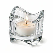 Clear glass candle holder with a lit white candle on a white background - thumbnail number 3
