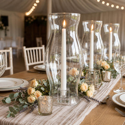 Hurricane Pillar Candle Lamp arrangements with peach roses lining a rustic reception table - thumbnail number 4