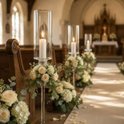 White vigil candles in glass holders lining elegant church wedding aisle - thumbnail number 3