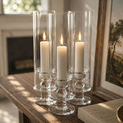 White vigil candles in clear glass holders on wooden table with warm glow - thumbnail number 7