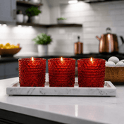 Three red hobnail votive candles on marble tray in modern kitchen setting - thumbnail number 8