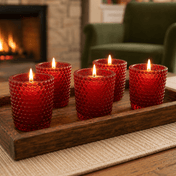 Red hobnail votive holders with lit candles on wooden tray in cozy living room - thumbnail number 7