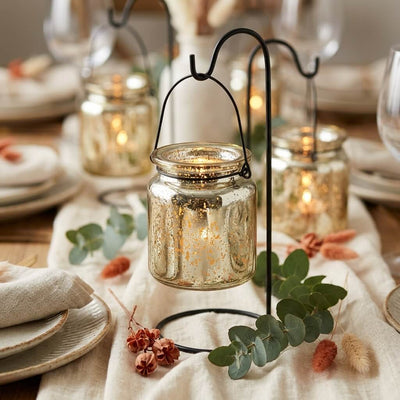 Gold mercury glass hanging holders on a decorated tablescape with eucalyptus and linen linens - thumbnail number 4