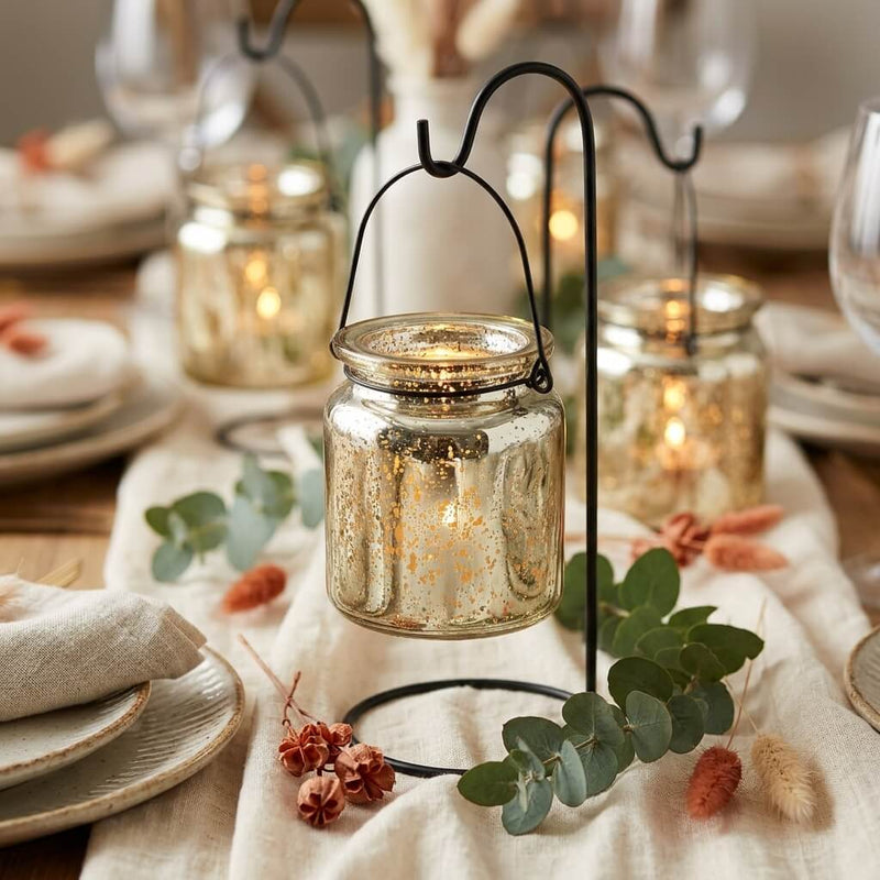 Gold mercury glass hanging holders on a decorated tablescape with eucalyptus and linen linens - thumbnail number 4