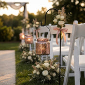Rose gold hanging candle holder with white floral decor beside outdoor wedding chairs - thumbnail number 5