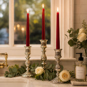 Red taper candles in silver holders with white roses by window - thumbnail number 7