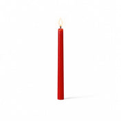 Red lit taper candle standing on white background - thumbnail number 2
