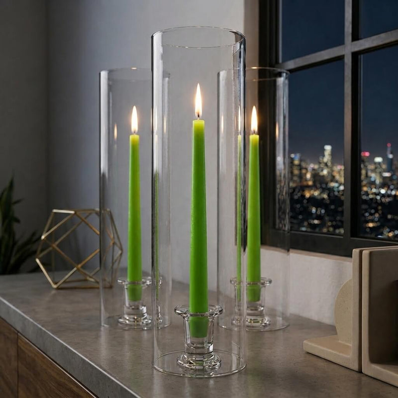 Lit green taper candles inside clear glass cylinders indoors - thumbnail number 7