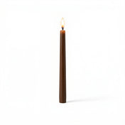 Single brown taper candle with flame on white background - thumbnail number 2