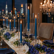 Blue taper candles with floral centerpiece and city view backdrop - thumbnail number 4