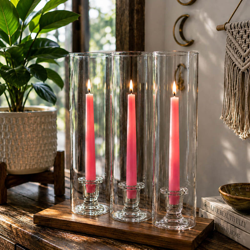 Lit pink taper candles inside tall glass candle holders - thumbnail number 6