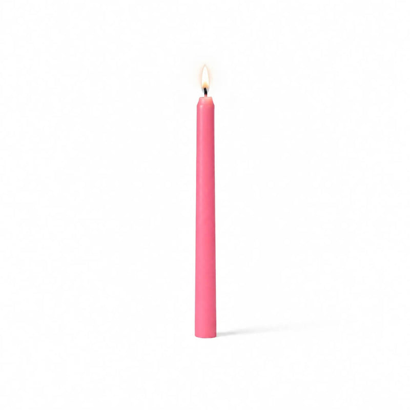 Single pink taper candle with flame on white backdrop - thumbnail number 2