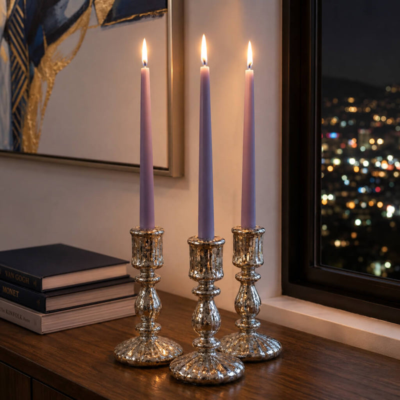 Three lavender taper candles on table beside window at night - thumbnail number 6