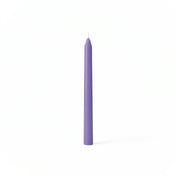 Single lavender taper candle on white backdrop - thumbnail number 1