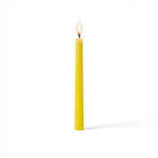 Single glowing yellow taper candle on white surface - thumbnail number 2