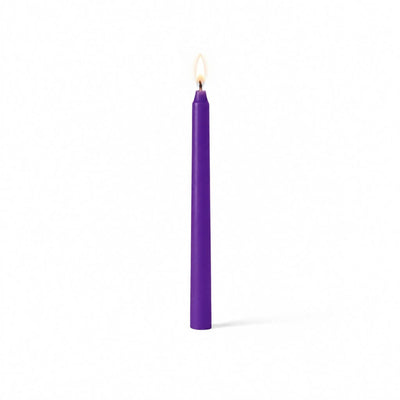 Purple lit taper candle standing on white background - thumbnail number 2