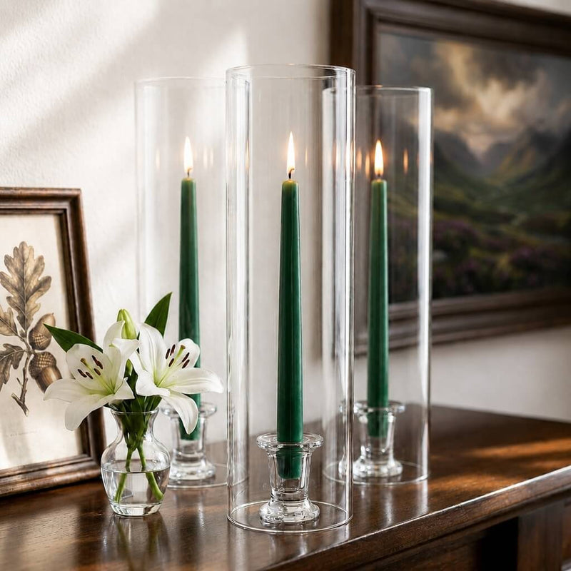 Green taper candles in tall glass cylinder holders on wooden console table - thumbnail number 6