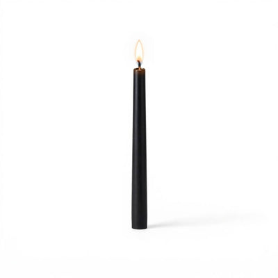 Black taper candle burning on white background - thumbnail number 2