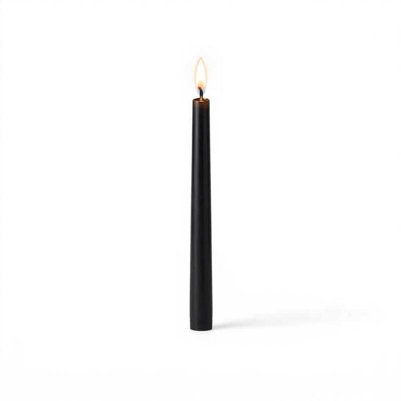 Black taper candle burning on white background - thumbnail number 2